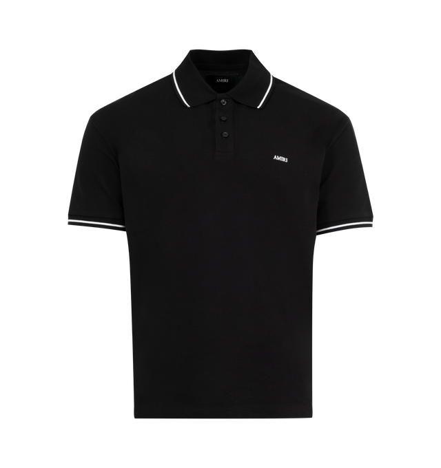 Image 1 of 2 - BLACK - AMIRI Polo Tee featuring polo collar, partial front button closure, embroidery logo detail at chest, short sleeves and stripe detail at collar and sleeves. 100% cotton. Made in Italy.