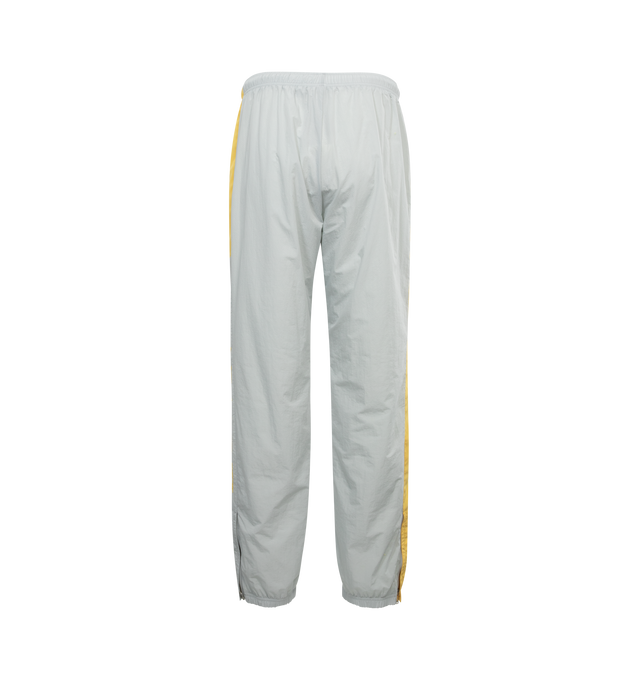 Image 2 of 4 - GREY - LANVIN LAB X FUTURE jogging pants in a relaxed fit will work equally well in a women's or men's wardrobe.  Jogging pants crafted from technical fabric in a neutral grey color with contrasting yellow stripe on the sides. Featuring Lanvin logo along the left leg, elasticated waist and leg bottoms, zipped side pockets. 100% polyamide, fully lined in 100% polyester. Made in Italy. 