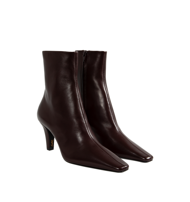 Image 2 of 4 - RED - Saint Laurent Josie Booties have square pointed toes, a tapered block heel with a Cassandre in bronze tone metal on the inside heel, and a side zip closure. 100% lambskin. Made in Italy.