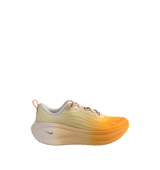 Image 1 of 5 - ORANGE - Nike Men's Vomero Plus Cheat Day SP Sneakers are crafted with engineered mesh uppers and feature a max-cushion performance silhouette inspired by the indulgent spirit of a "Cheat Day." Designed with a vibrant orange-dusted upper balanced by neutral tones, this special-edition style combines dual Air Zoom units with responsive ZoomX cushioning for exceptional comfort and energy return. Finished with a durable rubber outsole, lace-up closure, and signature Nike branding throughout. M