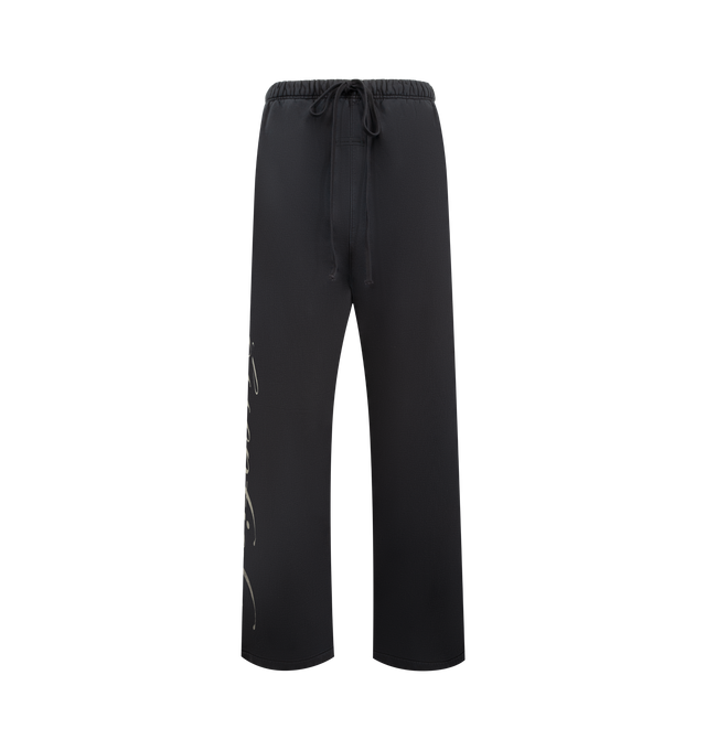 Image 1 of 4 - BLACK - FEAR OF GOD ESSENTIALS Heavy Fleece Lounge Sweatpant featuring 520gsm heavy fleece treated with a pigment dye, wide-leg silhouette, bold Essentials script logo on the leg, encased elastic waistband with elongated drawcords, side seam pockets and a Fear of God Essentials rubberized label stitched at the center front. 100% cotton.