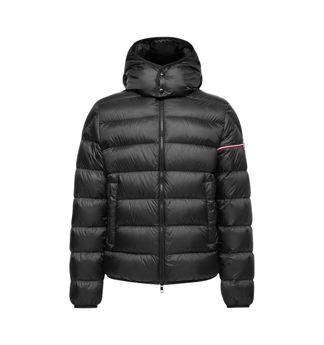 Image 1 of 1 - BLACK - Moncler Men's Ravenlock Hooded Short Down Jacket is crafted from lightweight nylon technique and features a streamlined quilted silhouette with a subtle tricolor accent at the shoulder that nods to the brand's heritage. Designed for lightweight warmth, this down-filled jacket is finished with a detachable hood, stand collar, two-way zip closure, welt pockets, elasticized hem, and signature logo patch at the sleeve. Main Material: 100% Polyamide/Nylon. Lining: 100% Polyamide/Nylon. Pad