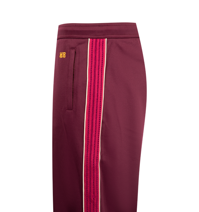 Image 3 of 3 - RED - WALES BONNER Essence Track Pants featuring concealed drawstring at elasticized waistband, three-pocket-styling, mock-fly, pinched seam at legs, stripe down outseams and logo embroidered. 55% polyester, 45% cotton.