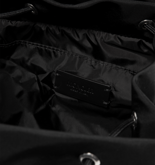 Image 3 of 3 - BLACK - MONCLER New Trick Backpack featuring recycled water-repellent nylon, nylon lining, leather trim, leather handle, adjustable straps, closure with buckle and drawstring fastening, zipped pockets and inner media pocket. L 17 cm x H 18 cm x D 10 cm. 100% polyester. Made in Italy.