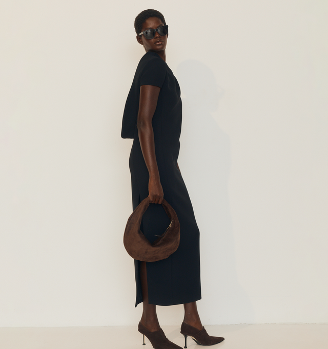Image 4 of 5 - BLACK - KHAITE Iryl Dress featuring a fluid, open-back dress, architectural structure, softly contoured side panels, a back slit, concealed zipper closure and lined in soft silk habotai. 100% polyester.