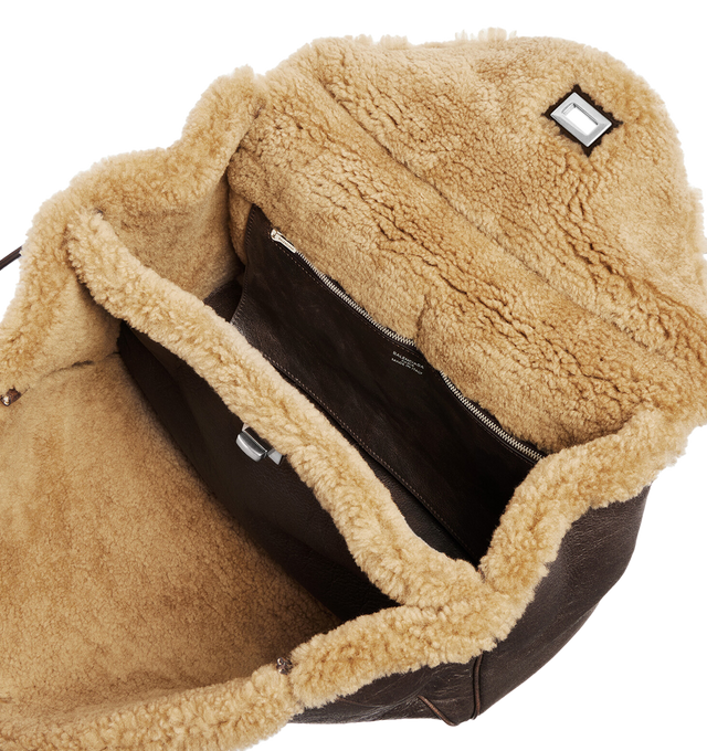 Image 4 of 4 - BROWN - BALENCIAGA Rodeo Handbag Medium in brown calfskin and beige shearling, aged-silver hardware featuring one handle, removable shoulder strap, removable cloche cls with two split rings, ribbon with Balenciaga logo on the front, turn lock closure, wide front pocket, 1 main compartment, 1 inner zipped pocket, 2 flat pockets at back, side snaps, 4 brass feet and Nappa lambskin lining. 13.8" x 9.6" x 4.3". Shearling, calfskin, polyester. Made in Italy.