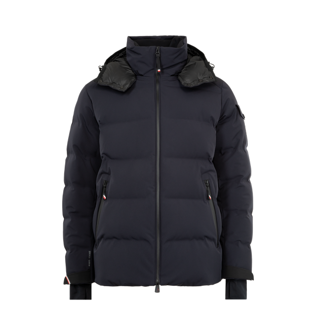 Image 1 of 4 - NAVY - MONCLER GRENOBLE Montgetech Down Jacket featuring a 2 way zip front closure, stand collar, removable hood, wrist gaiters, thumbhole cuffs, and an interior powder skirt. Lined with down fill. 87% polyamide/nylon, 13% elastane/spandex. Lining: 100% polyester. Padding: 90% down, 10% feather. Made in Romania.
