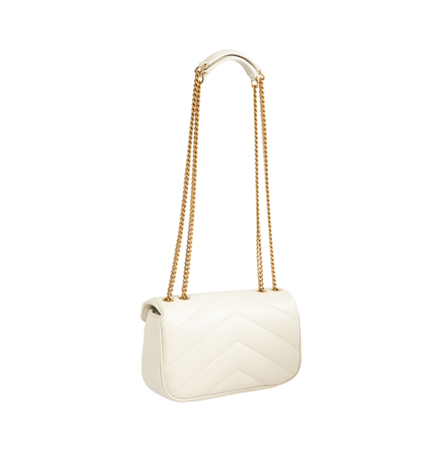 Image 2 of 3 - CREAM - Saint Laurent Women's Loulou Mini Chain Bag is crafted from lambskin leather and features the house's iconic chevron-quilted topstitching, a leather-and-chain shoulder strap, and a lightweight mini silhouette. Designed for versatile crossbody wear, this compact style is finished with bronze-toned hardware, a magnetic snap closure, a leather-lined interior, and a removable leather pouch. Main Material: Lambskin Leather. Lining: Leather. Hardware: Bronze-Toned Brass. Dimensions: 20 x 12