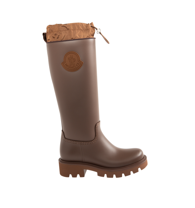 Image 1 of 4 - BROWN - MONCLER Kickstream High Rain Boots featuring PVC and nylon upper, fabric insole, TPU welt, EVA tread, drawstring fastening and waterproof. Calf height 35 cm. Sole height 4 cm. 100% polyvinyl chloride. Lining: 80% polyamide/nylon, 20% elastane/spandex. Sole: 100% elastodiene. Made in Italy.