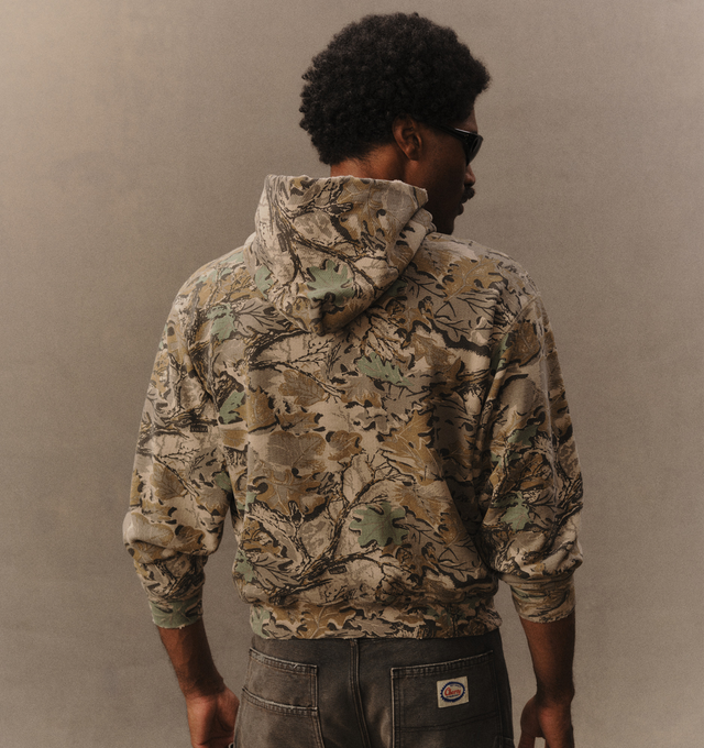 Image 6 of 6 - GREEN - Cherry LA Men's Chevron Pullover Hoodie is crafted from custom cotton fleece and features a boxy-fit silhouette with a classic pullover design. Designed with a chest patch, distressed detailing, and a branded label at the cuff, this everyday essential combines a relaxed fit with Cherry LA's signature worn-in aesthetic. Main Material: Custom Cotton Fleece. Made in Los Angeles, California.