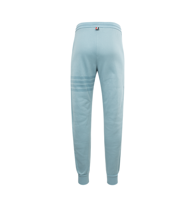 Image 2 of 3 - BLUE - THOM BROWNE Double Face Knit Tonal 4-bar Sweatpants featuring drawstring waistband with silver tone aglets, 4-bar detailing, slip side pockets, name tag applique above left hem, button cuffs with signature grosgrain trim and signature striped grosgrain loop tab. 100% cotton. 
