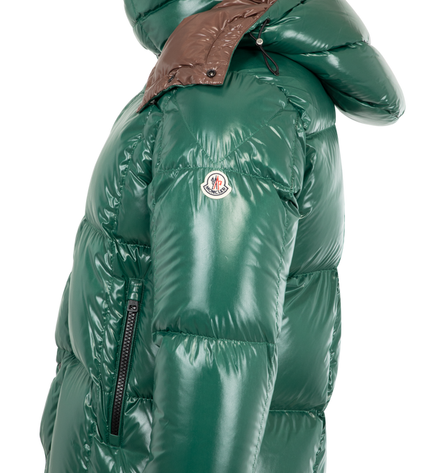 Image 4 of 4 - GREEN - MONCLER Parana Hooded Short Down Jacket featuring nylon laqu lining, down-filled, detachable and adjustable hood, zipper and snap button closure, zipped pockets and hem with drawstring fastening. 100% polyamide/nylon. Padding: 90% down, 10% feather. Made in Romania.