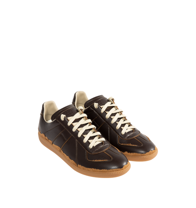Image 2 of 5 - BROWN - MAISON MARGIELA Replica Sneakers featuring low-top sneakers with distressed contrast overlays, numeric signature tongue, rubber sole with a classic gum finish and white stitching at the back. Upper: 54% Polyamide-Nylon, 46% Polyurethane. Lining: 100% Cotton. Inside: 100% Calf Leather. Made in Italy.