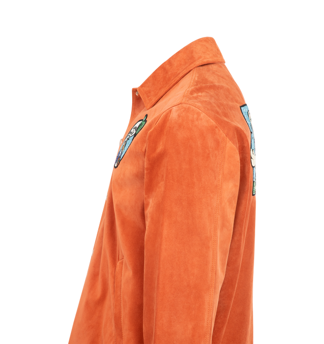 Image 3 of 3 - ORANGE - Moncler x Gilga Farm Designed by Donald Glover Navel Suede Shirt Jacket is inspired by creative life on Donald Glover's Gilga Farm. The Moncler Genius suede overshirt is embellished with beaded motifs depicting the Mon Duck character at the farm. The shacket's color palette references sunsets seen over the Californian farm. Crafted from cow leather suede featuring snap button closure, zipped pockets, hem with drawstring fastening and beaded logo motifs at the side and back. Made in I