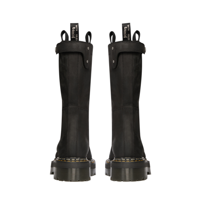 Image 6 of 7 - BLACK - Dr. Martens x Rick Owens FW26 Quad Sole Pull On Boot in Nubuck Leather. These Women's Dr. Martens boots are reimagined by Rick Owens and are mid-calf height with a steel toe cap and palladium-finish hardware, including snaps and a side zipper. They feature a topstitched seam arcing over the front foot, a stitched heel counter, two side pull tabs, and a woven Dr. Martens AirWair heel loop in black and pearl. The boots are finished with a Quad sole and a yellow and pearl welt stitch. Th