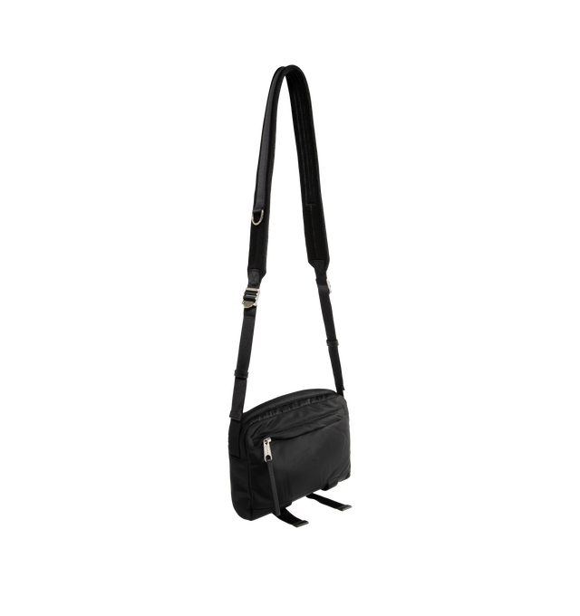 Image 2 of 3 - BLACK - Balenciaga Men's Sleek Nylon Zip Bag is crafted from lightweight nylon and features a streamlined silhouette designed for versatile everyday wear. Finished with an adjustable shoulder strap for a customizable fit, this designer bag features a secure zip closure and a Balenciaga logo debossed with silver at the front for a subtle signature finish. Main Material: Nylon. Closure: Zipper. Strap: Adjustable Shoulder Strap. Details: Silver Debossed Balenciaga Logo at Front.