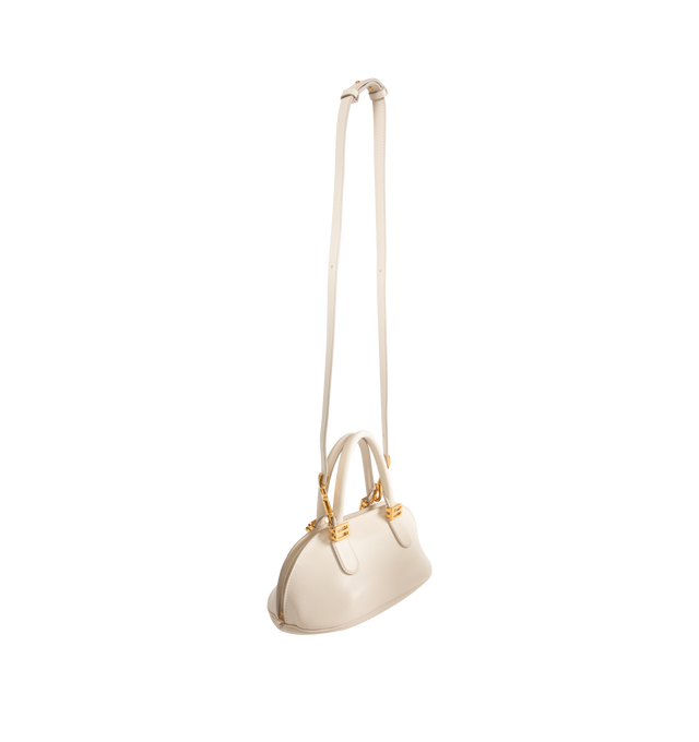 Image 2 of 4 - WHITE - BALENCIAGA Bolero Bowling Bag Mini featuring smooth calfskin, two handles with Bolero B logo, adjustable and removable strap, shoulder, crossbody and hand carry, aged-gold hardware, zipped closure with leather pull tab and ring, zipped pocket on the bottom with leather pull tab and ring, 1 main compartment and contrasting nappa lambskin lining. 11.8" x 5.1" x 6.3". Calfskin. Made in Italy.