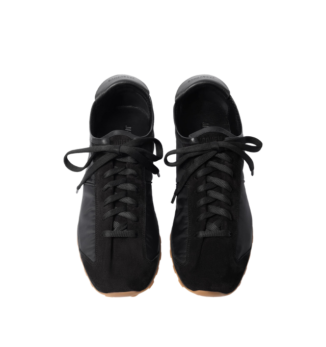 Image 4 of 4 - BLACK - JACQUEMUS Les Tennis Sneaker featuring soft sneaker in hydro-treated suede and nylon, almond-shaped toe, flat laces, embossed logo on the tongue, embossed logo on the heel tab, removable leather-covered insole and rubber outsole in a circle and square shape. 100% polyamide. Outsole: 100% thermoplastic polyurethane. Made in Portugal.