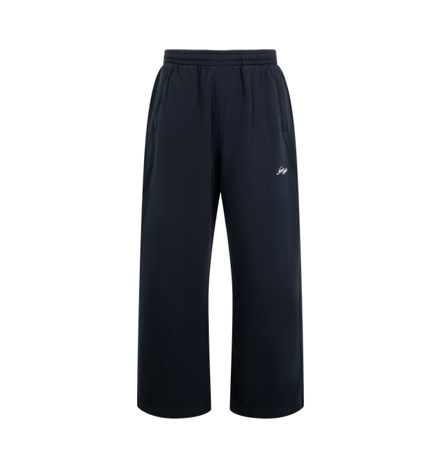 Image 1 of 3 - BLUE - Acne Studios Fleece Logo Sweatpants are crafted from brushed organic cotton fleece and feature a loose unisex silhouette with a mid-rise waist and long, baggy legs. Designed with an elasticated waistband and adjustable drawcord, these designer sweatpants are finished with side zip pockets and an embroidered seasonal logo for a signature finish. Main Material: 100% Cotton. Fit: Loose Unisex Fit. Rise: Mid-Waist. Details: Long Baggy Legs, Elastic Waistband with Drawcord, Side Zip Pockets