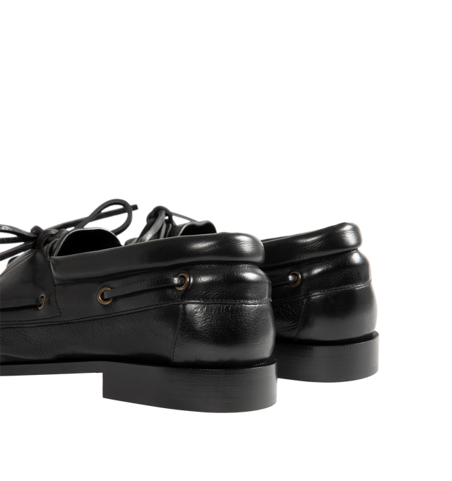 Image 3 of 4 - BLACK - Saint Laurent Mens Boat Shoes are crafted from metal-free tanned calfskin leather. Feature a lace-up boat shoe silhouette, hand-stitched moc toe, gold-tone CASSANDRE hardware, leather sole, and 1.5 cm heel height. Main Material: Calfskin Leather; Hardware: Brass; Sole: Leather. Made in Italy.