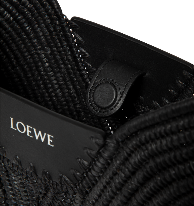 Image 3 of 3 - BLACK - Loewe Womens Swing Bag is crafted from raffia with calfskin trim. Features a fortune cookie silhouette, adjustable shoulder and crossbody strap, magnetic closure, handcrafted Canutillo detailing, signature buckle, unlined interior, and embossed LOEWE logo. Dimensions: 35 22 11 cm; Strap Length: 1797 cm; Strap Drop: 653 cm. Main Material: Raffia, Calfskin. Made in Spain.