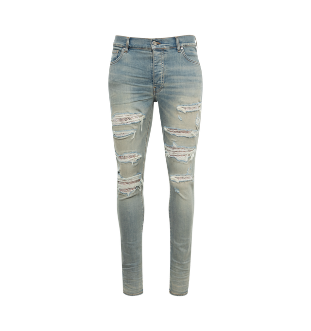 Image 1 of 2 - BLUE - AMIRI Thrasher Jeans featuring skinny-fit, stretch denim, fading, whiskering, and distressing throughout, belt loops, five-pocket styling, button-fly, exposed crystal-cut underlay at legs, logo patch at back waistband, logo plaque at back pocket and contrast stitching in tan. 92% cotton, 6% elastomultiester, 2% elastane. Trim: 100% preciosa crystals. Made in United States. 