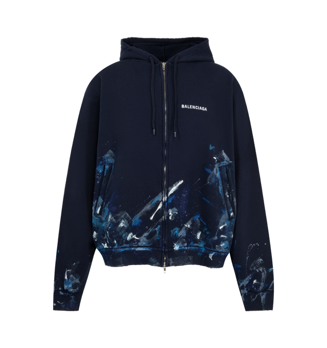Image 1 of 2 - BLUE - Balenciaga Men's Paint Splatter Zip-Up Hoodie is crafted from dry cotton fleece and features an oversized fit with a full zip-up closure, adjustable hoodie, kangaroo pockets, and long sleeves. A paint-splatter print and embroidered Balenciaga chest logo define the design, while ribbed cuffs and a ribbed waistline complete the silhouette. Main Material: 100% Cotton. Embroidery: 100% Polyester. Made in Portugal.