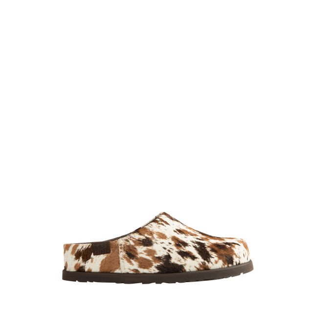 Image 1 of 4 - BROWN - Ugg Women's Otzo Western Clog is crafted with a hand-painted cow hair upper and reimagines the brands signature clog silhouette through a Western-inspired lens. Designed for all-day comfort, this distinctive style features a leather and RWS wool jersey lining enhanced with a peppermint-based anti-odor treatment, along with a contoured EVA footbed for cushioning and support. A leather and microfiber sockliner provides additional comfort, while the lightweight rubber outsole with 30% FC
