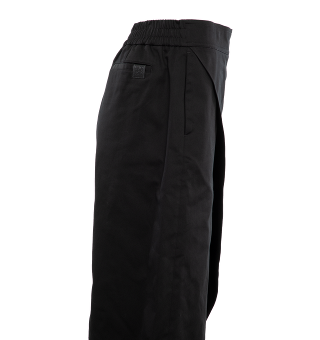 Image 3 of 5 - BLACK - Loewe Trousers crafted in lightweight cotton with a folded panel at the front. Featuring a relaxed fit, cropped length, mid waist, loose leg, partly elasticated waistband, side zip fastening, seam pockets, rear welt pocket with Anagram embossed leather tab placed on the rear pocket. Made in Italy. 