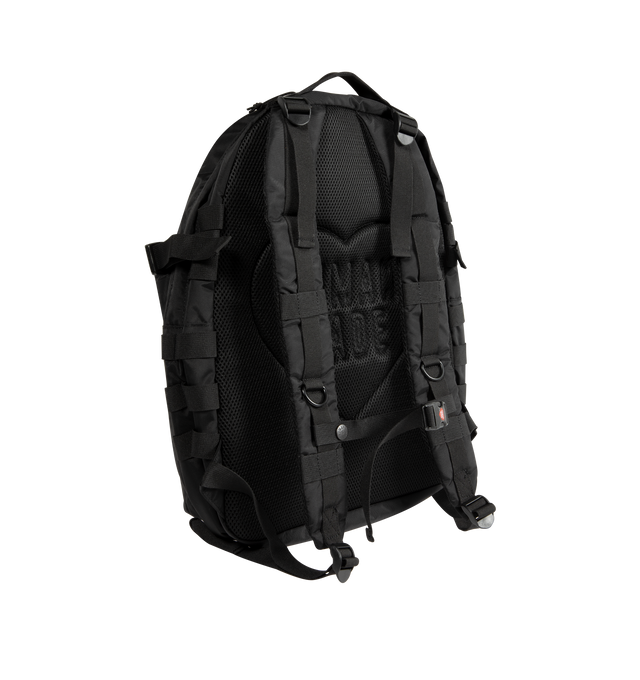 Image 2 of 3 - BLACK - Human Made Military Backpack is crafted from lightweight nylon Oxford fabric and features a military-inspired silhouette with stencil-style graphics and modular attachment functionality. Designed with a front flap pocket with buckle strap closure, a cushioned sleeve for a laptop or tablet, mesh-padded back panel, adjustable waist belt, and B4-sized storage capacity for everyday versatility. Main Material: Shell: 100% Nylon. Lining: 100% Polyester. Dimensions: 44 cm H x 32 cm W x 11 cm