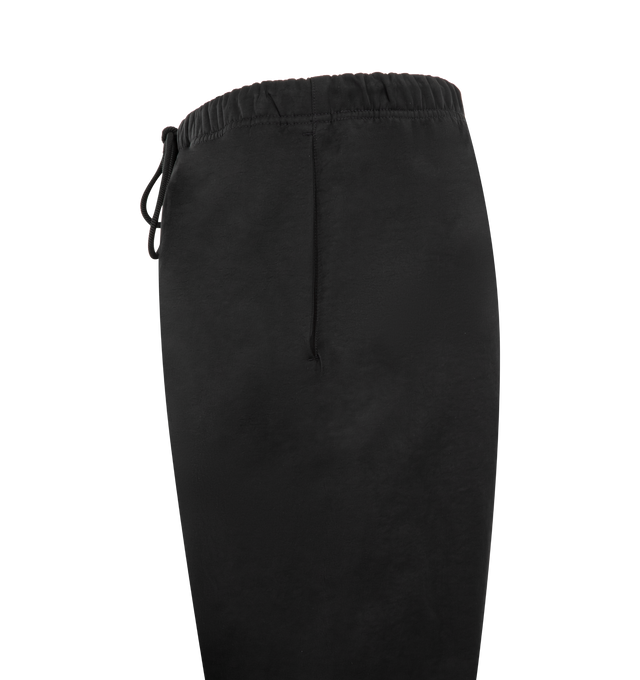Image 3 of 4 - BLACK - FEAR OF GOD ESSENTIALS Active Trace Relaxed Drawstring Pant featuring drawstring waistband, side seam pockets, rubberized logo patch and midweight ripstop fabric. 100% nylon.