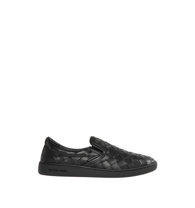 Image 1 of 5 - BLACK - BOTTEGA VENETA Sawyer Slip-On Sneakers featuring padded collar, elasticized gusset at sides, logo flag at outer side, logo printed at padded footbed, logo embossed at textured rubber midsole and treaded rubber sole. Upper: leather. Sole: rubber. Made in Italy. 