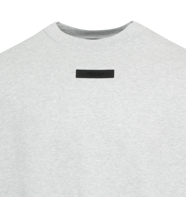 Image 2 of 2 - GREY - FEAR OF GOD ESSENTIALS Crewneck T-Shirt featuring rib knit crewneck, rubberized logo patch at chest and back, dropped shoulders and dolman sleeves. 100% cotton. Made in Viet Nam. 