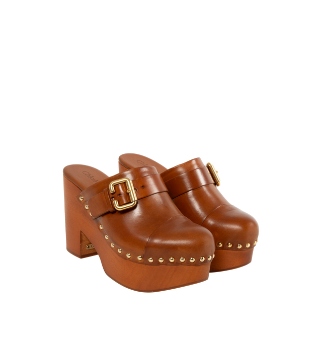 Image 2 of 4 - BROWN - CHLOE Jeannette Shoe featuring a shiny cowhide upper with a chunky heeled wooden structure, polished hardware, gold-tone studs along the upper and a Chlo-branded plate. 4.3" heel. Upper: shiny cowhide. Inner sole: calfskin. Main lining: calfskin. Sole: 80% African padauk wood, 20% thermoplastic polyurethane.