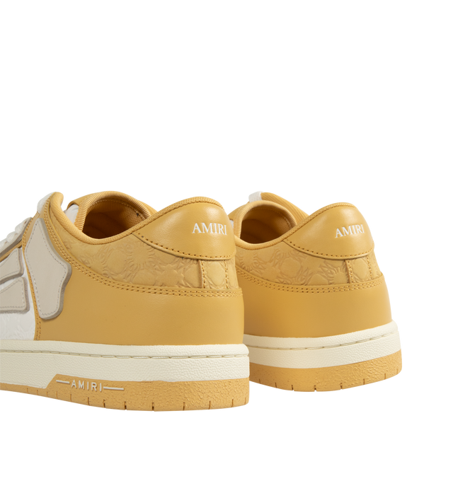 Image 3 of 5 - NEUTRAL - Amiri Men's Quad Skel Top Low Sneakers are a lace-up style with perforation details, signature graphics, leather appliques, and two-tone rubber soles. Leather uppers. Made in Vietnam.