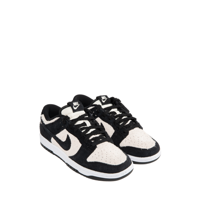 Image 2 of 5 - WHITE - NIKE Dunk Low Retro SE Sneaker featuring iconic Panda colorblocking in a hairy suede iteration, paired with plush padding, foam midsole offers lightweight, responsive cushioning, rubber outsole with classic pivot circle, low-cut collar and hairy Panda tag.