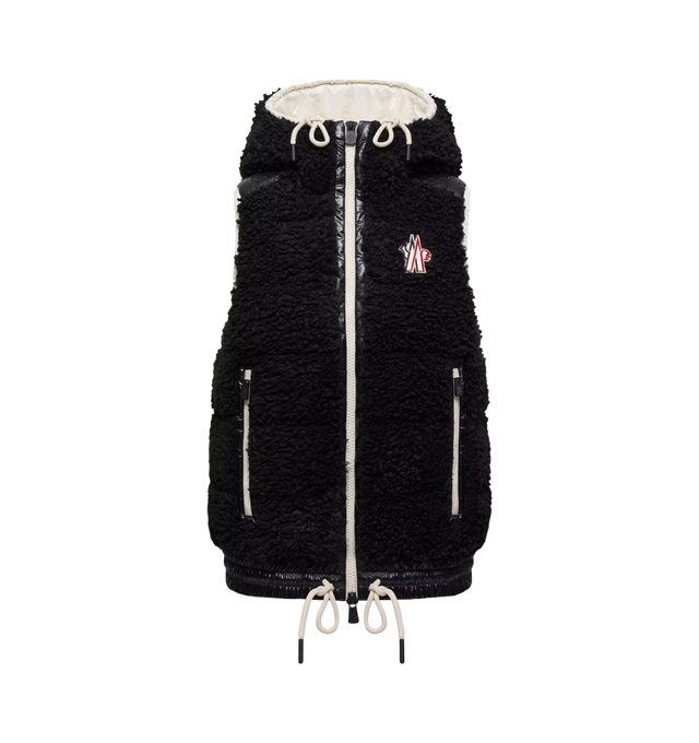 Image 1 of 1 - BLACK - Moncler Women's Teddy Hooded Down Vest is crafted from plush teddy fleece and features a down-filled construction, nylon laqu accents, and an adjustable hood. Designed for skiing, snowboarding, hiking, and trekking, this cold-weather layer is finished with a front zip closure, zipped pockets, an elasticized hem, and a signature logo patch. Main Material: 100% Polyester. Contrast Material: 100% Polyamide/Nylon. Lining: 100% Polyamide/Nylon. Hood Lining: 100% Polyamide/Nylon. Padding: 9
