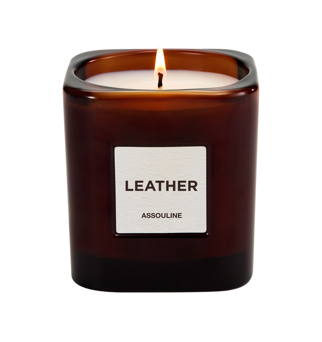 Image 2 of 3 - RED - Assouline Library Candle Leather is a luxury scented candle that captures the warm, sophisticated ambiance of leather-bound books and refined interiors with a rich fragrance blending leather, clove, tobacco, freesia, orris, and vetiver. Housed in a heavyweight amber glass vessel with a textured paper label, this designer candle is crafted from a premium soy, coconut, and paraffin wax blend for a clean, even burn and exceptional scent throw. Top Notes: Leather, Clove. Heart Notes: Tobac