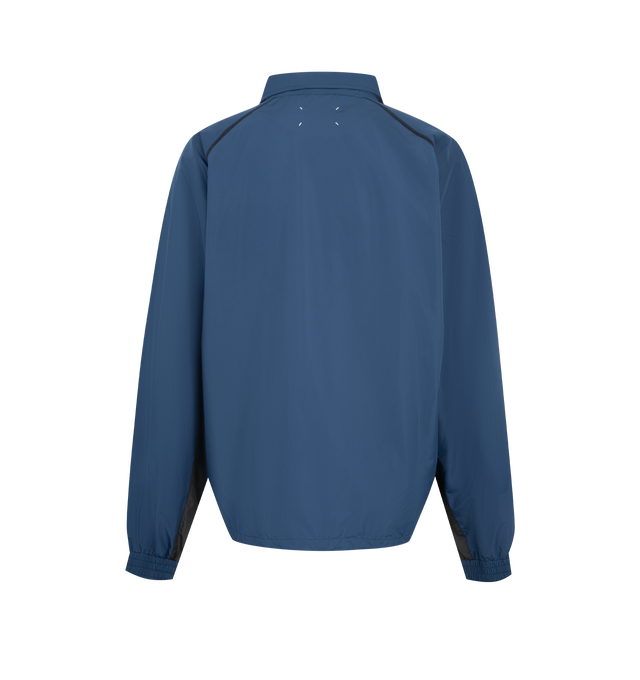 Image 2 of 3 - BLUE - MAISON MARGIELA Contrast Panel Track Jacket featuring contrasting panels, a standing collar, raglan sleeves, zip-through front, grey inserts running across the shoulders and down the side seams for a graphic effect and signature four white stitches at the back. 100% polyester. Made in Italy.