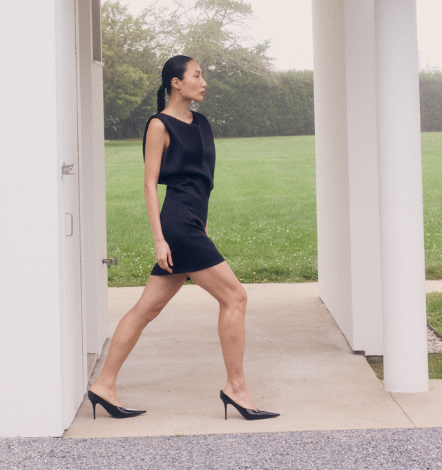 Image 3 of 5 - BLACK - KHAITE Toma Dress featuring a sculptural minidress that doubles as a tunic. Sharpened by clean shoulders and animated by bonded Italian crepe. Undulating bodice designed to blossom and bloom from slim-fitting skirt. Concealed zipper closure at back. 83% acetate, 17% viscose.