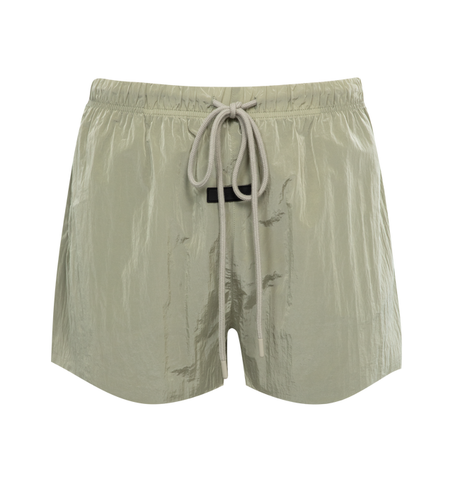 Image 1 of 3 - GREEN - FEAR OF GOD ESSENTIALS Running Short featuring an encased elastic waistband with elongated drawstrings, cropped length, side seam pockets and a rubberized label at the center front. 100% nylon.  