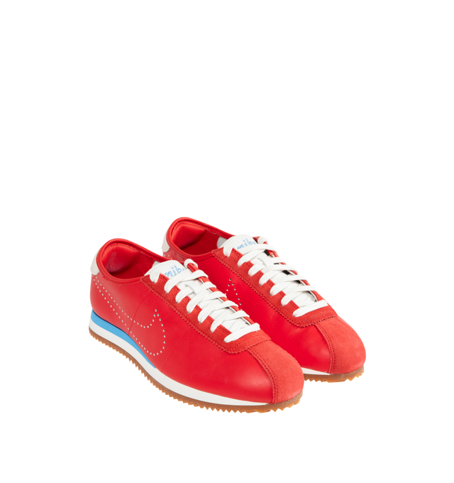 Image 2 of 5 - RED - NIKE Cortez Sneaker featuring leather upper with suede trim and rubber gum sole, lace-up front, embroidered Nike logo on tongue, perforated signature swoosh at sides and embroidered logo at back counter.