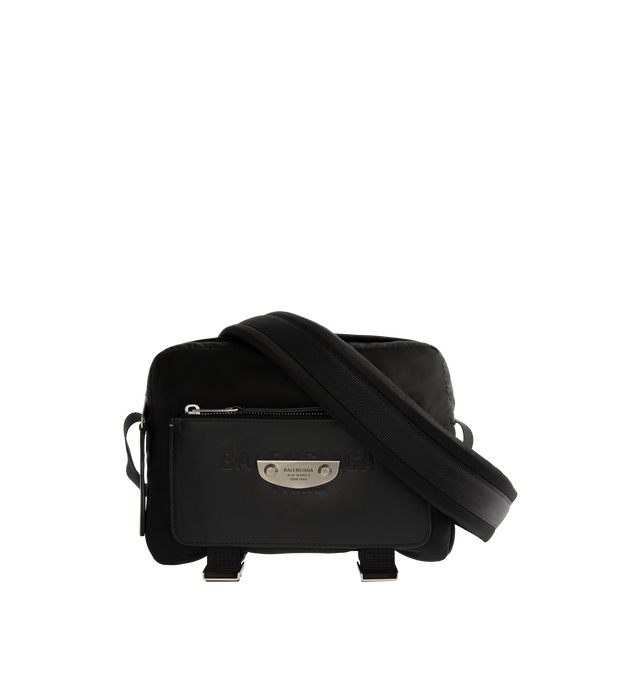 Image 1 of 3 - BLACK - Balenciaga Men's Sleek Nylon Zip Bag is crafted from lightweight nylon and features a streamlined silhouette designed for versatile everyday wear. Finished with an adjustable shoulder strap for a customizable fit, this designer bag features a secure zip closure and a Balenciaga logo debossed with silver at the front for a subtle signature finish. Main Material: Nylon. Closure: Zipper. Strap: Adjustable Shoulder Strap. Details: Silver Debossed Balenciaga Logo at Front.
