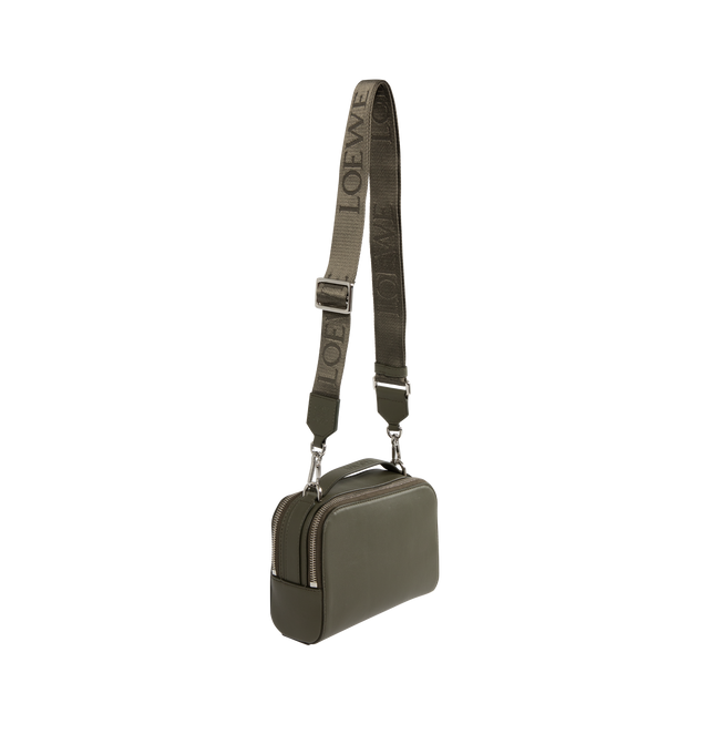 Image 2 of 3 - GREEN - LOEWE Mini Crossbody Camera Bag in satin calfskin featuring two zipped compartments, crossbody or hand carry, adjustable and detachable LOEWE webbing strap, herringbone cotton canvas lining and debossed LOEWE Anagram patch. Satin calf. 13 cm x 18 cm x 8.5 cm. Made in Portugal.