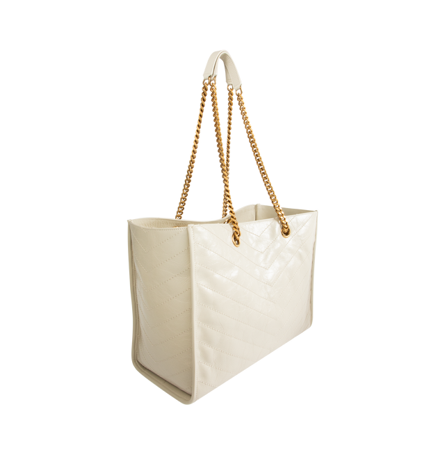 Image 2 of 3 - WHITE - SAINT LAURENT Niki Shopping Bag in vintage leather featuring vintage calfskin, chevron topstitching, cotton lining, bronze-tone hardware, magnetic snap-button closure and one zip pocket. 13" x 10.6" x 5.5". Strap drop: 10.6". Calfskin. Made in Italy.
