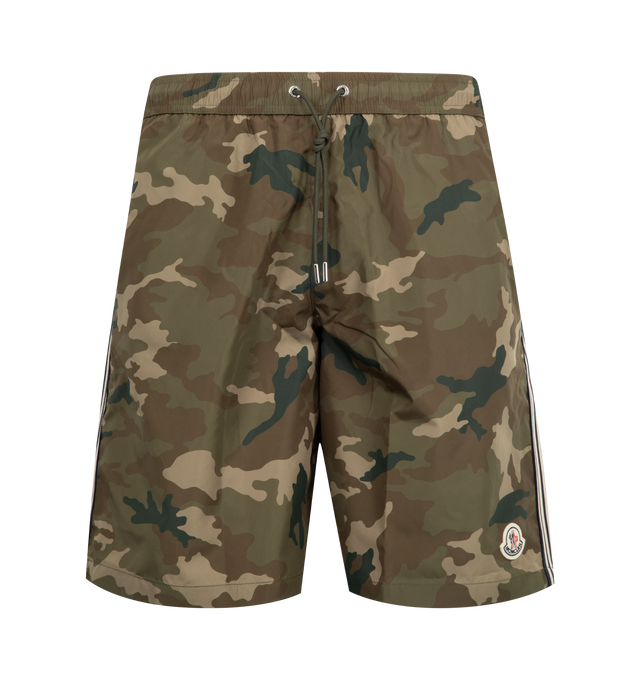 Image 1 of 3 - GREEN - MONCLER Swim Trunks featuring mesh lining, elastic waistband with drawstring fastening, side pockets, back pockets with snap button closure, striped trim along the legs and logo patch. 100% polyester.