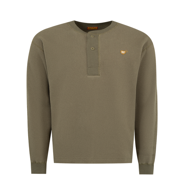 Image 1 of 2 - GREEN - HUMAN MADE Henley Neck Shirt featuring textured cotton thermal fabric, long sleeves, heart logo patch on the right chest, brand logo print on the back and ribbed collar and cuffs 100% cotton.