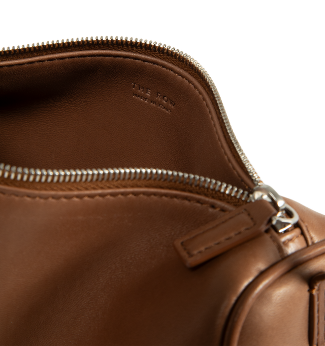 Image 3 of 3 - BROWN - The Row 90's Bag featuring top handle bag in finely grained calfskin leather with softly rounded edges, leather piping and adjustable slim leather strap. 7.7 x 4.5 x 3 in. 100% calfskin leather. Made in Italy.