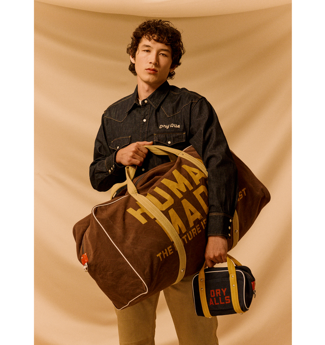 Image 8 of 8 - BROWN - HUMAN MADE Canvas Boston Bag Large featuring thick, tough cotton canvas, bio-washed for a vintage-like feel, graphics appear on both sides, external pocket and an internal zip pocket, heart-shaped rivets and 100L capacity. 100% cotton.