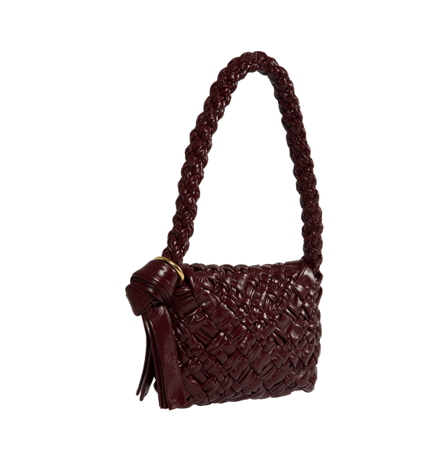 Image 2 of 3 - PURPLE - Bottega Veneta Kalimero Citt Shoulder bag in soft foulard Intreccio 100% calfskin leather with sliding shoulder strap, metallic ring and knot detail. Featuring unlined interior with single interior zipped pocket, magnetic closure, brass-finish hardware. Measures 7.1" tall X 9.8" wide x 2.2" deep with 11.8" strap drop. Made in Italy. 